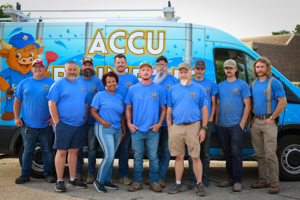 ACCU Plumbing team standing beside service van